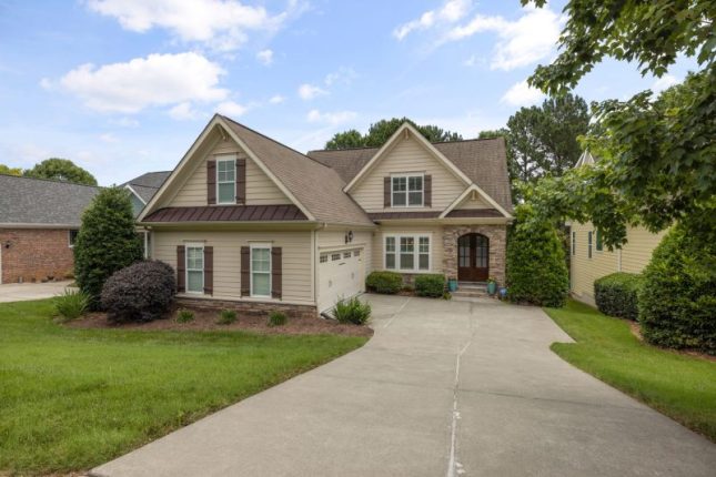 Beautiful suburban family house with a well-maintained lawn and driveway.