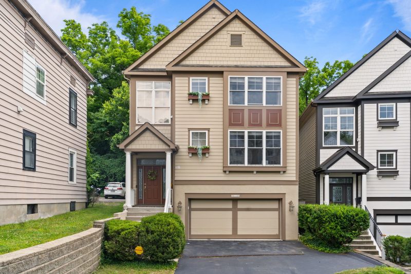 Modern suburban home in Cincinnati with a garage and a well-maintained garden.
