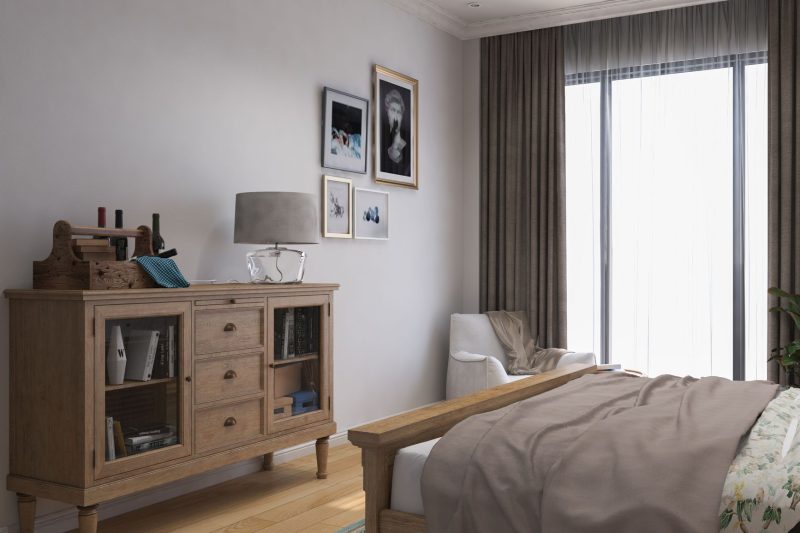 Stylish bedroom with a wooden cabinet, cozy decor, and abundant natural light.